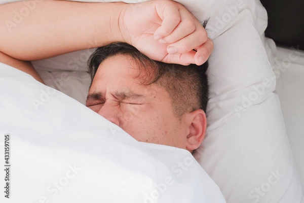 Fototapeta person sleeping in bed