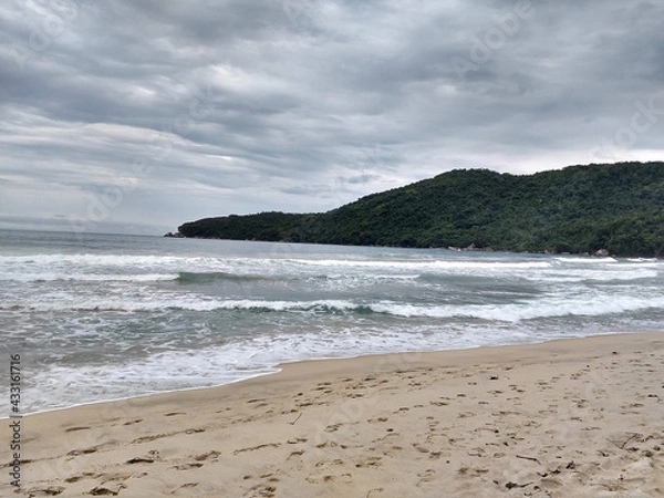 Fototapeta beach with pareia and rocks with cloudy sky