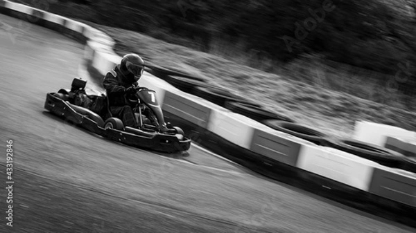 Fototapeta A panning shot of a racing kart as it circuits a track.