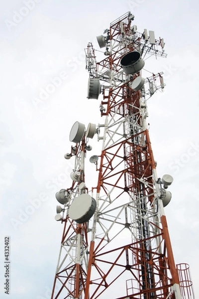 Fototapeta two cellular communication towers on a cloudy day
