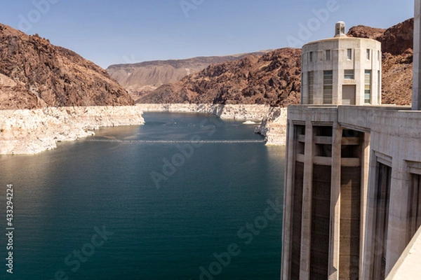 Obraz Lighter rock shows the pervious water level of Lake Mead near the intake towers of Hoover Dam

