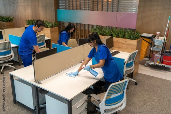 Fototapeta 
Group of cleaners clean an empty office space