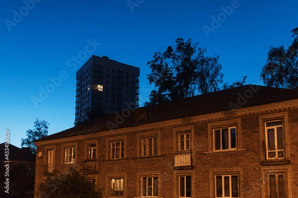 Fototapeta the light burns in one window of the multitude in a multi-storey residential building