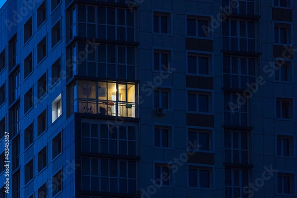 Fototapeta the light burns in one window of the multitude in a multi-storey residential building