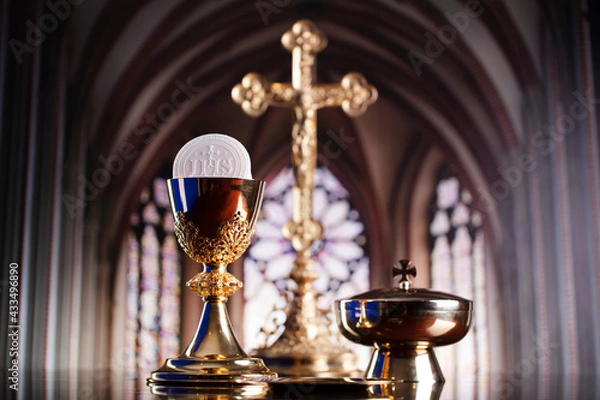 Fototapeta First Holy Communion. Catholic religion theme. Crucifix, the Croass and Golden chalice and wafer on the altar.