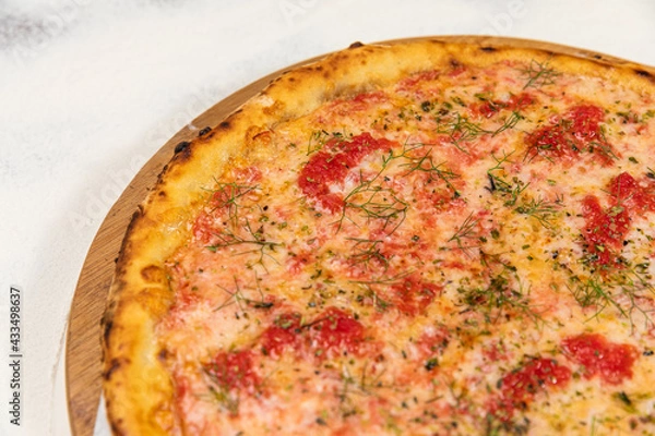 Fototapeta Pizza Homemade Artesanale Close Up Detail on a Round Wooden Plate with Flour Background Table
