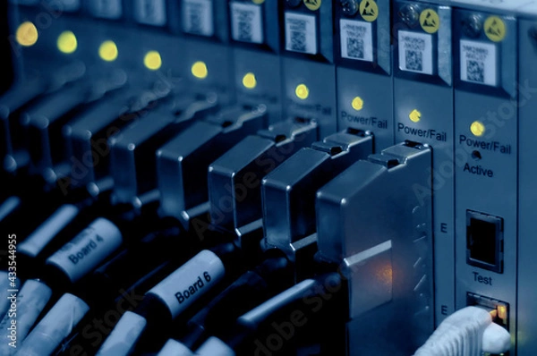 Fototapeta Network connection technology with broadband aggregation carrier electronic equipment, row of data cables and status LEDs to show working status of data center equipment in mobile telecommunications
