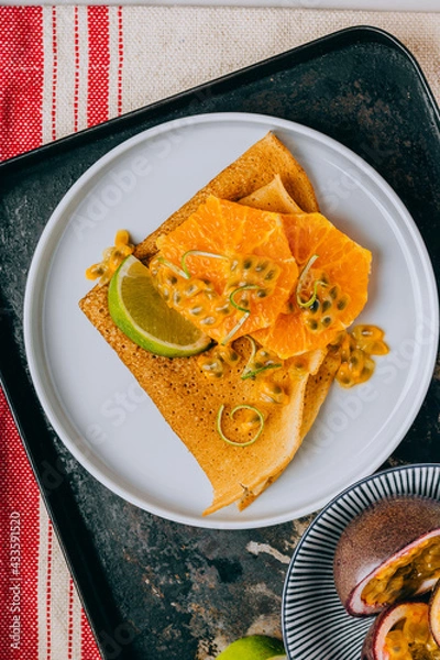 Fototapeta Crepes Or Thin Pancakes With Delicious passion fruit and lime.
