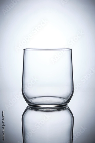 Obraz empty whiskey glass on white background with reflection isolated