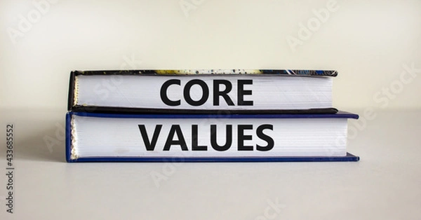 Fototapeta Core values symbol. Books with words 'core values' on beautiful wooden table. White background. Business and core values concept. Copy space.