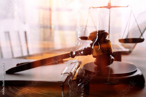Fototapeta Business and lawyers discussing contract papers with brass scale on desk in office. Law, legal services, advice, justice and law concept picture with film grain effect