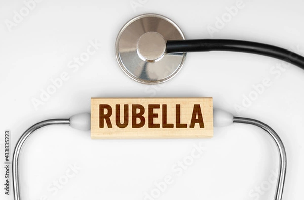 Fototapeta On the table is a stethoscope and a wooden plate with the inscription - RUBELLA