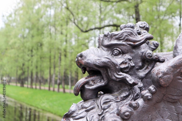 Fototapeta lion statue on the bridge in the park springtime