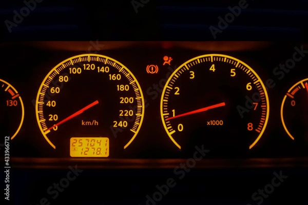 Fototapeta speedometer, tachometer, indicator, hand brake, and the airbag indicator on the dashboard of a car close up