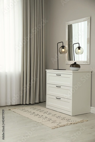 Fototapeta Hallway with stylish chest of drawers and mirror. Interior design