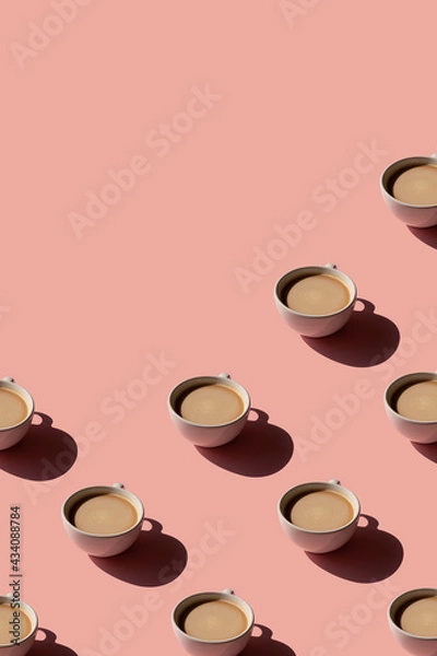 Fototapeta Cup of coffee pattern on pink background with place for text. Sunlight minimal trendy concept
