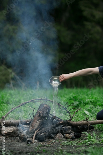 Fototapeta A man puts out a fire in the forest.