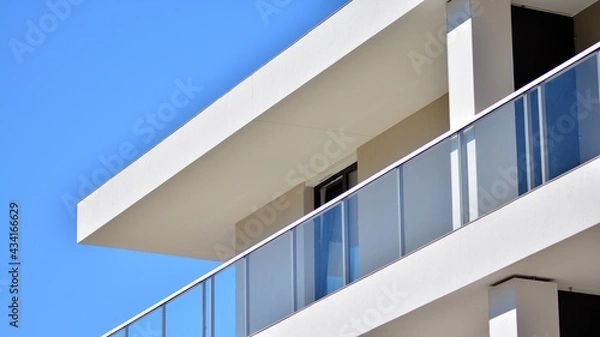 Fototapeta Condominium and apartment building with  symmetrical modern architecture. Detail in modern residential flat apartment building exterior. Fragment of new luxury house and home complex. 
