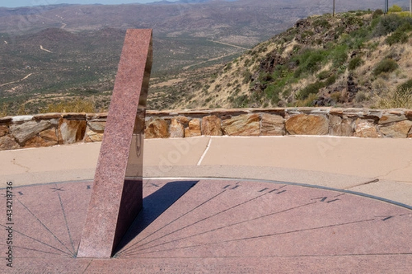 Fototapeta large sundial at scenic lookout point with mountains in the background