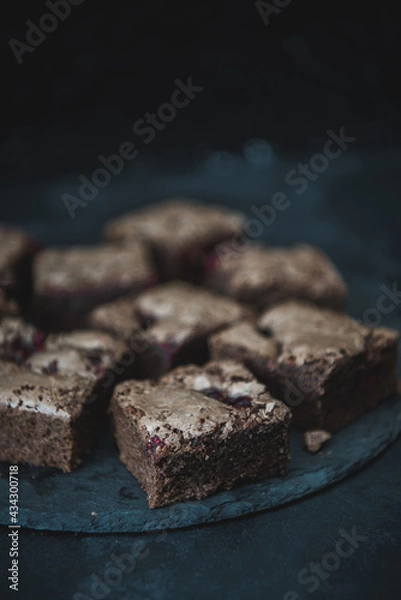 Fototapeta Tasty vegetarian brownie made from chocolate and cacao. Delicious chocolate pie. Selective focus. Flat lay composition with fresh brownies on dark background. Homemade dessert. No sugar pastry