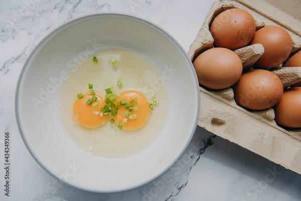 Obraz Fresh raw brown chicken eggs.Raw uncooked egg in white bowl.
