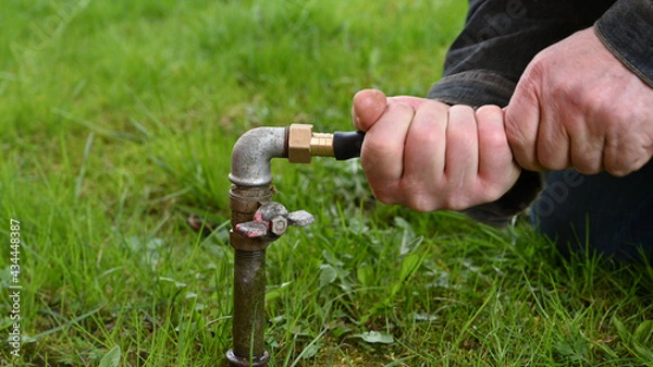Fototapeta Man Fixing Garden Water Pipe