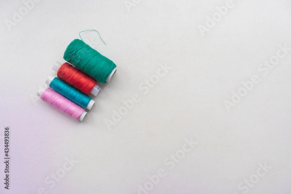 Obraz Colourful thread spools isolated on a white