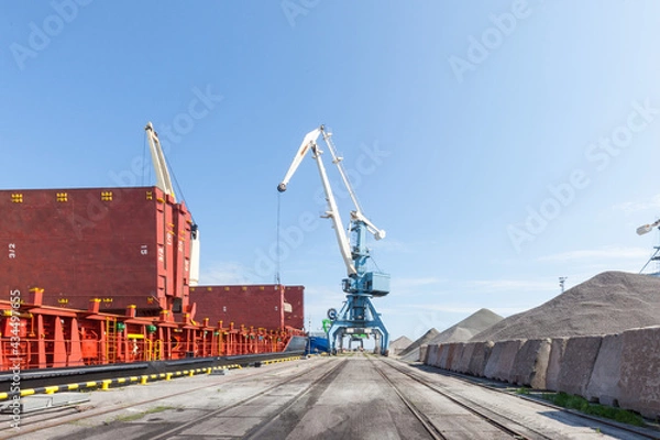 Fototapeta Loading and unloading of vessels on industrial terminal	