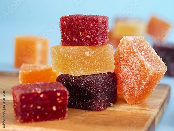 Fototapeta A colorful traditional French fruit jellies (Pâte de fruits). It's a sweet dessert which is main ingredients are concentrate fruits paste, sugar and pectin surrounding with sugar crystal 