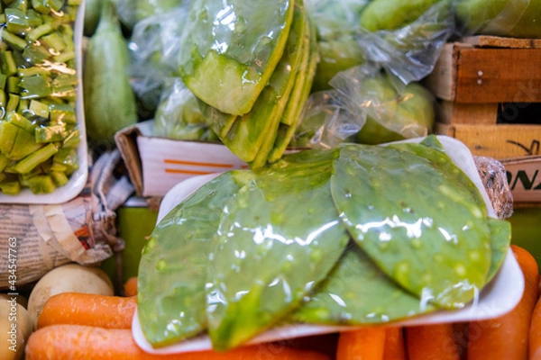 Fototapeta Close-up of colorful vegetable stand with Mexican nopales wrapped in plastic