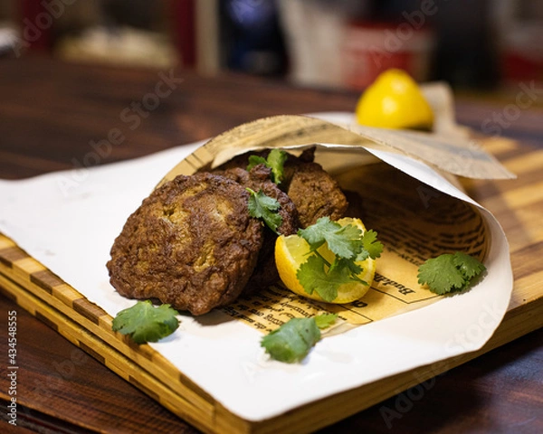 Fototapeta Liver cakes on a cutting board wrapped in white paper