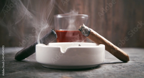 Fototapeta Glass of whisky, ashtray and cigars on the table.
