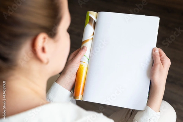 Obraz Female hands open blank catalog, magazines, book mock up