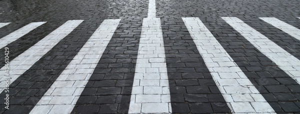 Fototapeta Old cobblestone pavement closeup and white line.