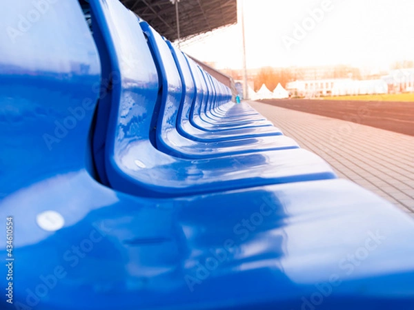 Fototapeta Empty stands in a stadium or sports field. The stands for the fans are blue. Without fans and fans