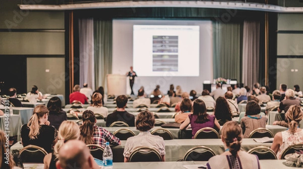 Fototapeta Audience in lecture hall participating at business conference.