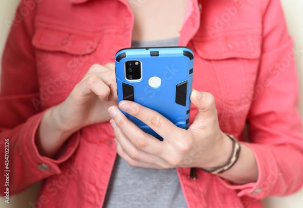 Fototapeta Mobile phone in hand. Woman using a phone