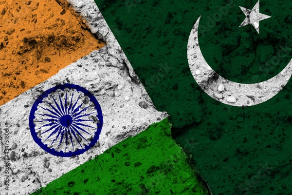 Fototapeta Concept of a Conflict between India and Pakistan with painted flags on a wall with a crack