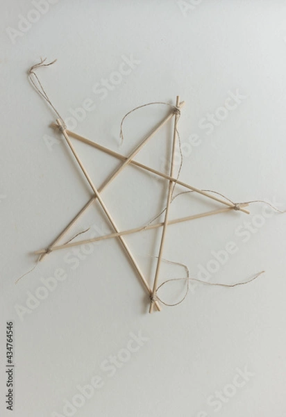 Fototapeta isolated bamboo skewer 5 pointed arts and crafts star tied with twine on paper