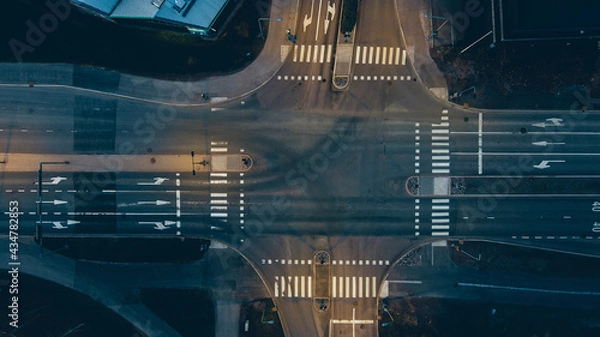 Obraz Aerial view of a junction with road markings at night.