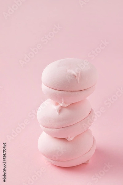 Fototapeta Stack of round pink marshmallows on pastel pink background, close-up. Three sweet zephyr candies for postcard.