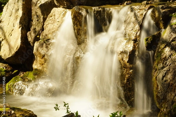 Obraz Water rushes down a waterfall.