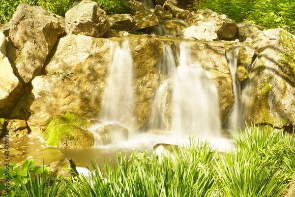 Obraz Water rushes down a waterfall.