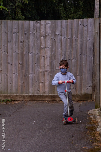 Obraz Cute Redhead Boy Riding A Red Scooter On A Path