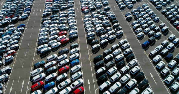 Obraz Cars parked in angled parking spaces - aerial view with a drone 4K