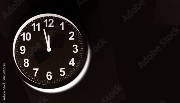 Fototapeta Close-up of a  modern fashioned white Wall Clock with numerals on the clock face. Clock with white frame on a black background. Pointers showing the time.  front view of the Watch out of center