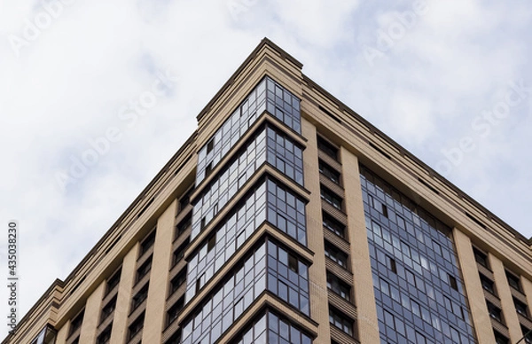 Obraz Corner of a brick modern residential building against the sky.
