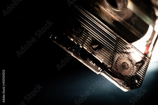 Fototapeta Minimalist Macro Closeup of Corner of See Through Cassette Tape on Black and Blue Backdrop
