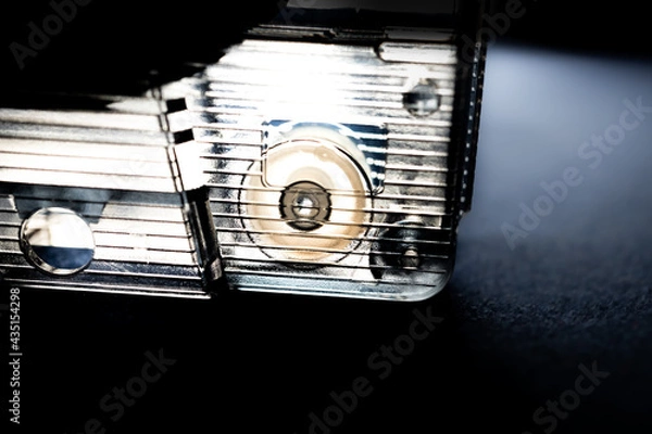 Fototapeta Minimalist Macro Closeup of Pinch Roller in Corner of Clear Cassette Tape