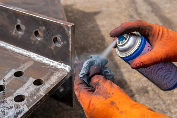 Fototapeta Step to use solvent remover spray into the rag to cleaning the welded surface before performing spray Liquid Penetrant for Non-Destructive Testing(NDT) with process Penetrant Testing(PT).